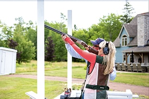 a woman train at skeet shooting at the Fox Harb’r Resort