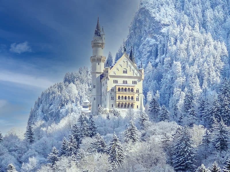 a castle in mountains covered with snow in the low season in Europe
