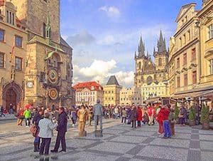 a crowd of people in an old city square