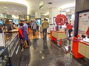 people shopping in a Parisian department store in the low season in Europe