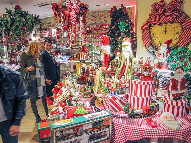 people looking at a Christmas display in a department store