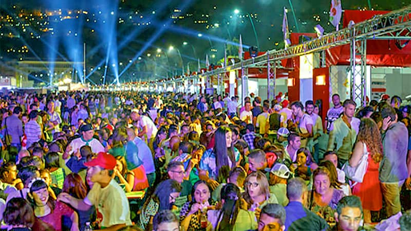 a very large crowd in an outdoor area at night