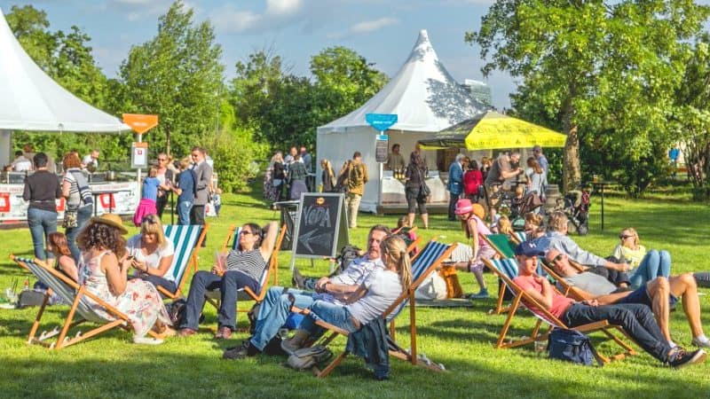 people sitting in lawn chairs at on of the food festivals in Europe in 2023