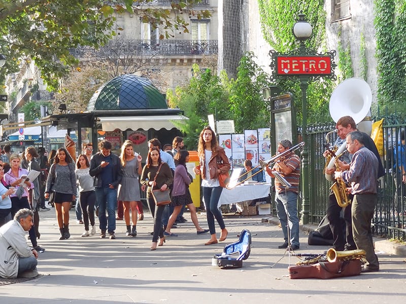 a street band playing for passerby near a metro station