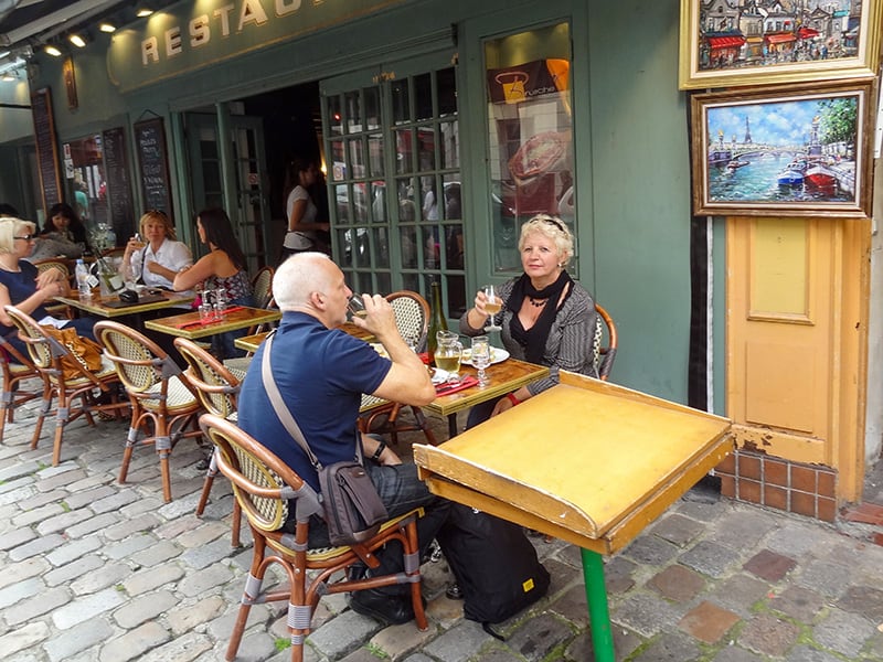 a man and woman having ,uch in an outdoor cafe