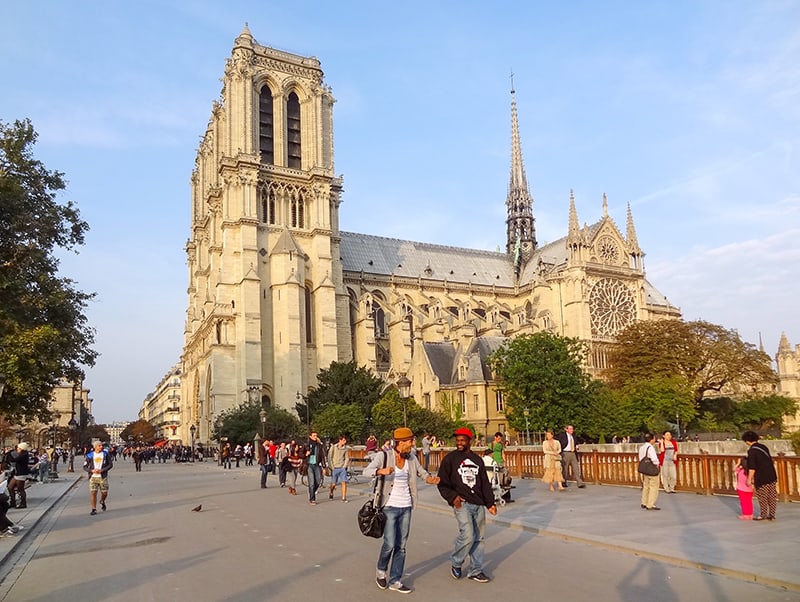 people walking past Notre Dame while on walks in Paris 