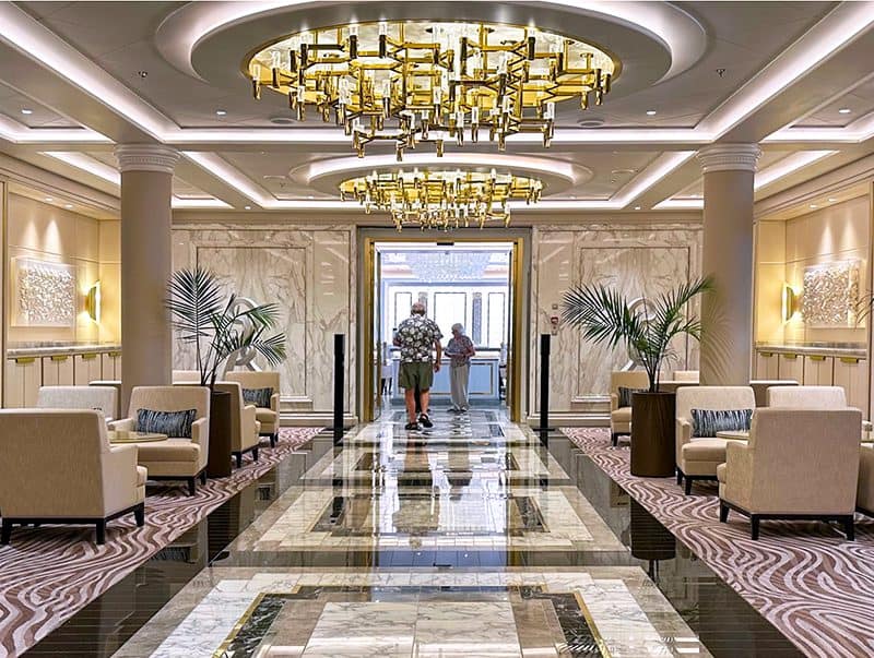 two people in an ornate marble hallway aboard the Seven Seas Splendor