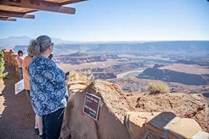 a woman in Utah National Parks looking across a vast canyon