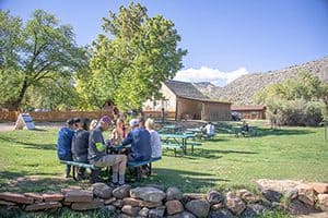 people sitting at a table having a picnic