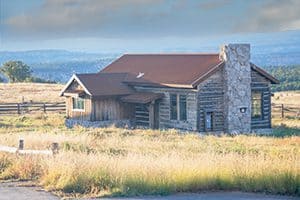 a house surrounded by tall grass on a prairie 