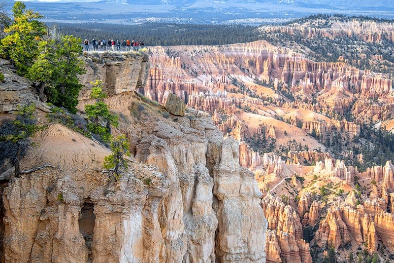 people looking at a huge rock formation of hoodoos in Utah National Parks