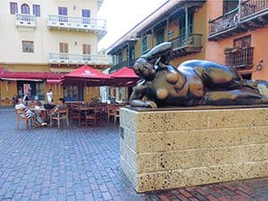 a large statue of a nude woman outside a cafe in Cartagena Colombia