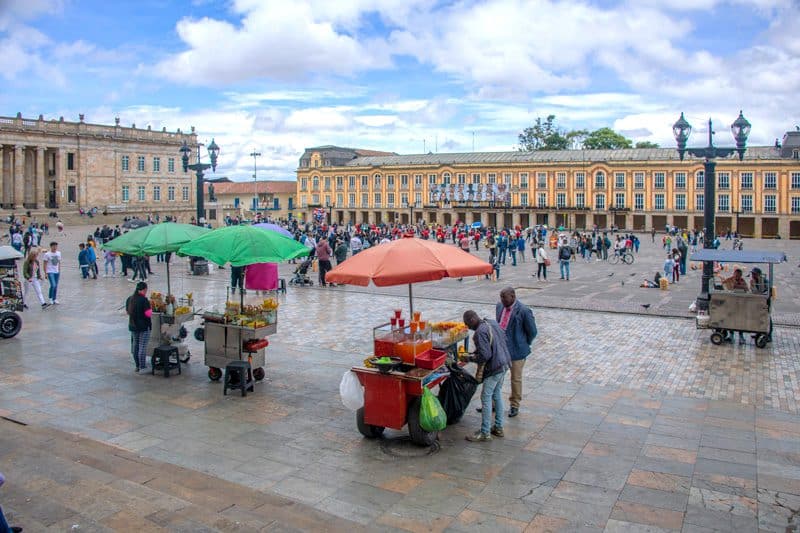 a crowd in a large colorful plaza