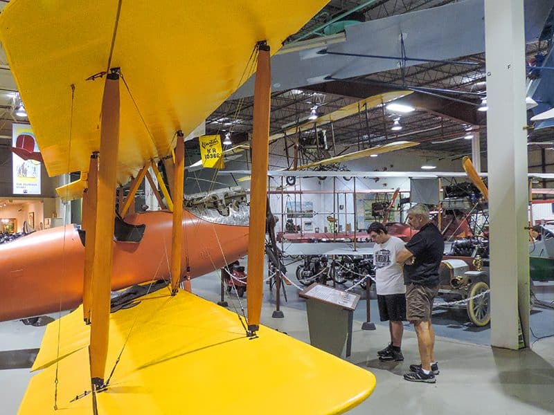 2 men looking at a biplane