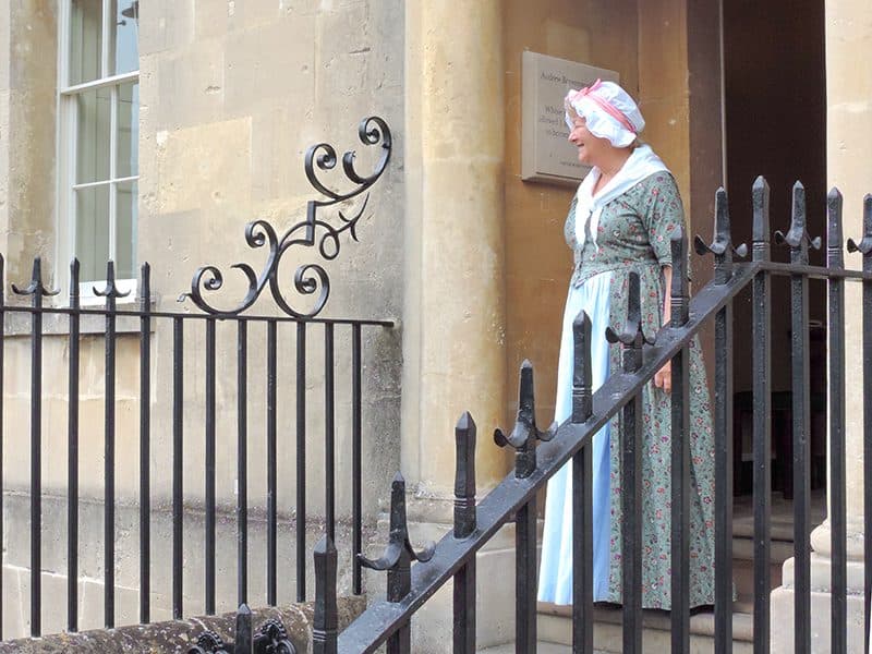 a housekeeper on a stoop seen on a day trip from London to Bath