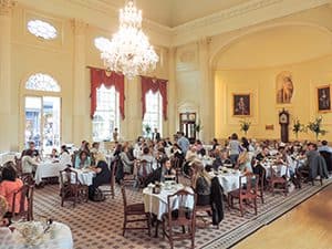 people dining in an ornate diningroom seen on a day trip from London to Bath