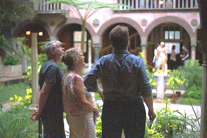 3 people admiring the architecture  in a small museum