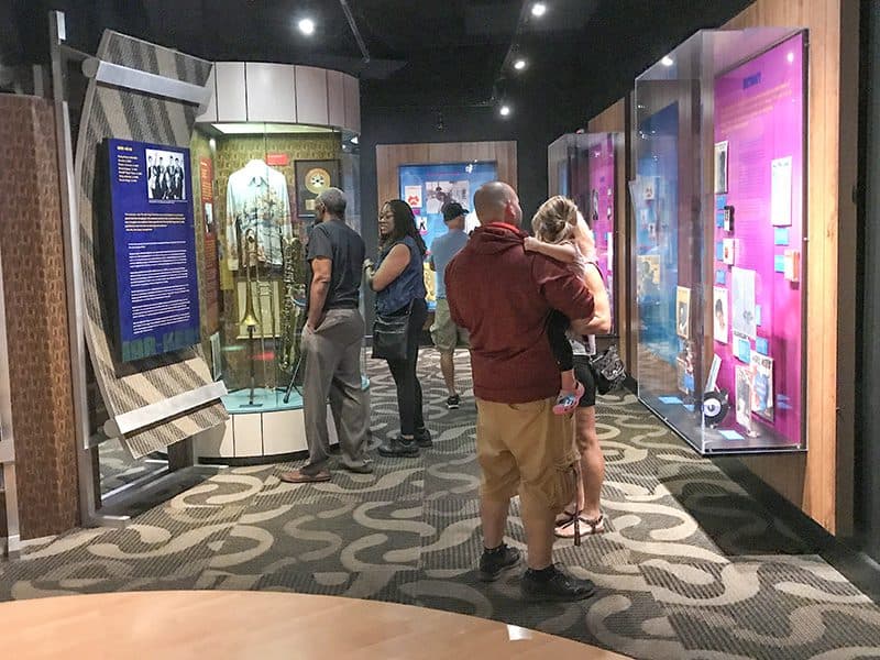 people looking at exhibits in a museum