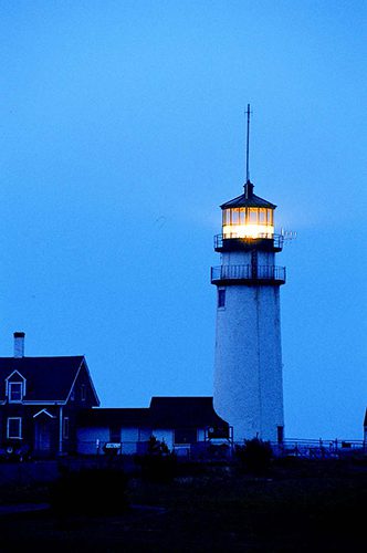 One of the U.S. lighthouse shining its beacon at dusk