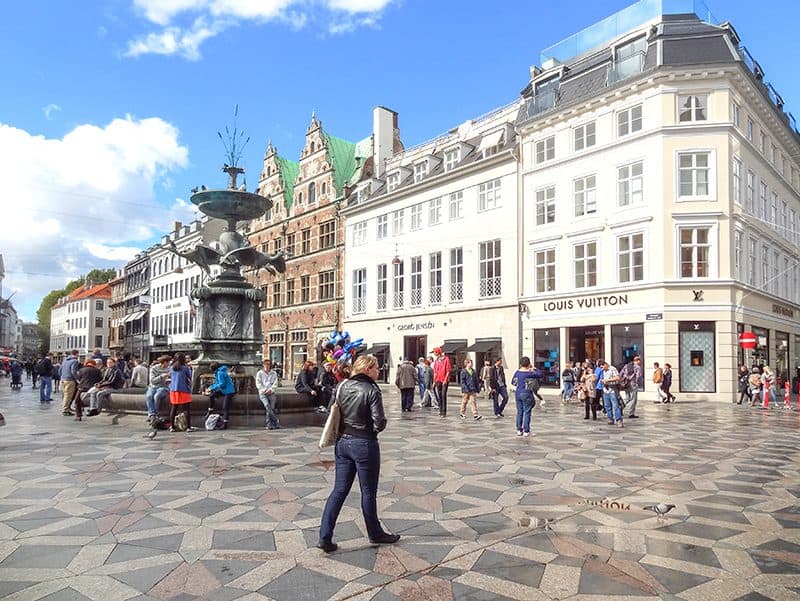 people sitting about a fountain on a stylish street seen during 2 days in Copenhagen