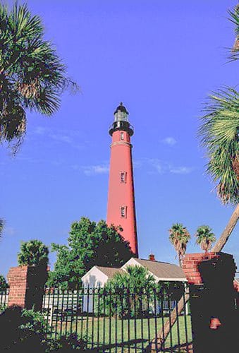 houses around a red brick tower