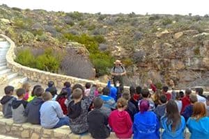 a park ranger speaking to a tour group in Carlsbad Caverns, one of the World Heritage sites in the USA