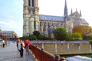 people walking by Notre Dame in PAris