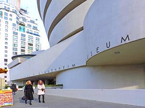 2 women walking past the Guggenheim Museum, one of the World Heritage sites in the USA