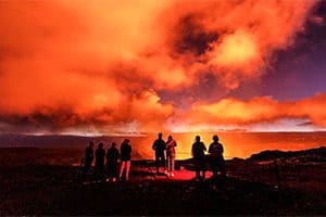 people watching the eruption of a volcano