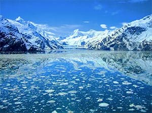 mountains on the rim of a bay filled with ice