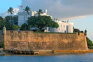 a castle on a shoreline ported by high walls