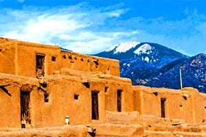 old adobe buildings in front of a distant mountain
