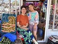 2 young women selling vegetables