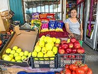 a woman with brighly colored fruits