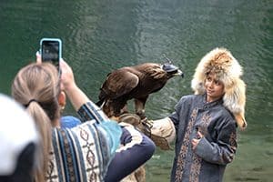 a child holding an eagle