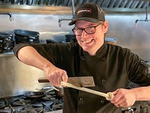 a chef sharpening a cleaver