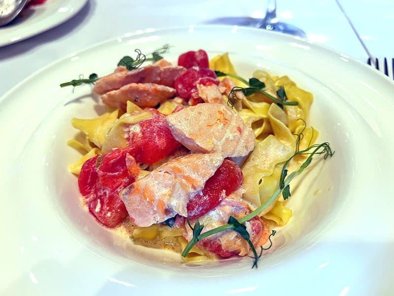 a colorful plate of fish, tomatoes and noodles seen on a visit to almaty kazakhstan