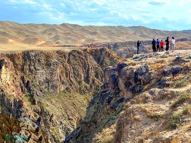 people standing along the top of a canyon