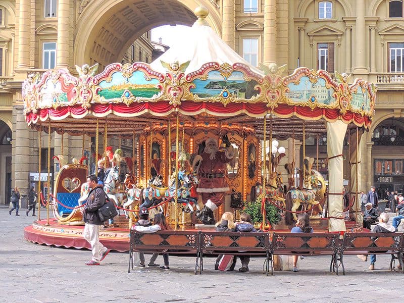 people by a antique carousel