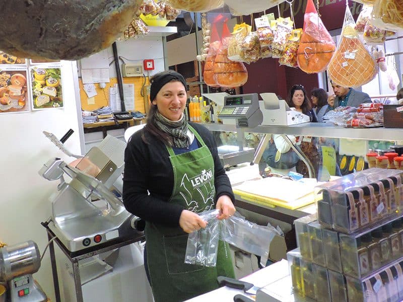 a woman in a butcher shop