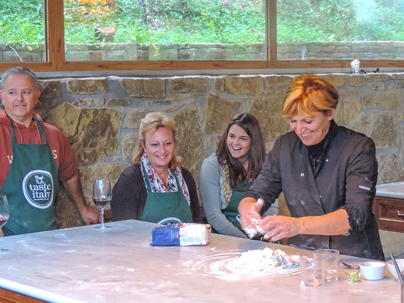 two women watching a chef make pasta in a Florence cooking class