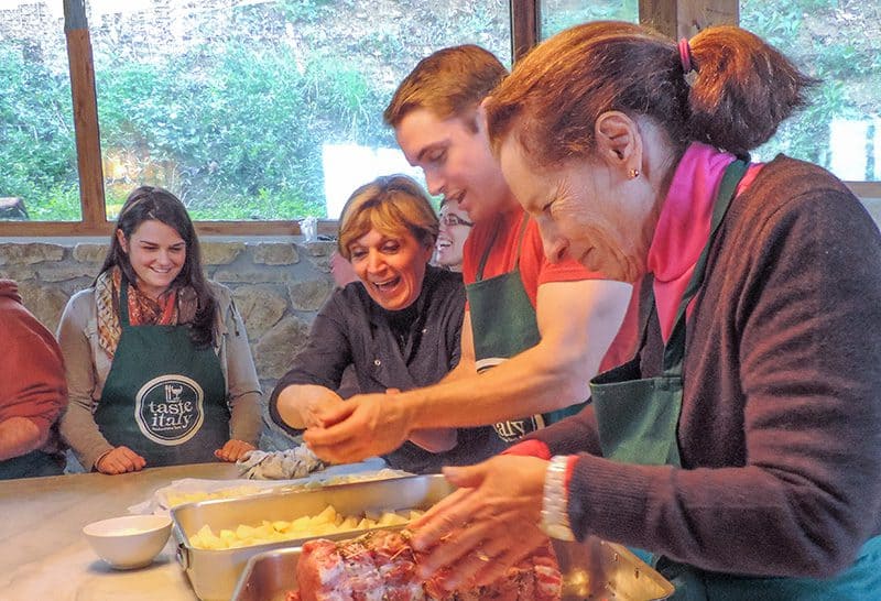 a group preparing a meal in a Florence cooking class