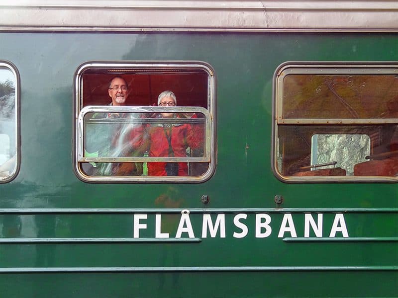 A couple looking out the window of the Flamsbana on the Flam Railway