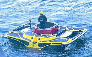 a man standing atop a small sumarine on the Viking Octantis