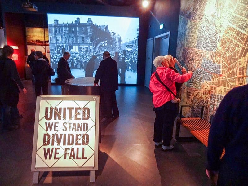 people looking at a wall map of a city in the Titanic Museum Belfast