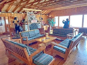 a woman taking a photo in a lodge