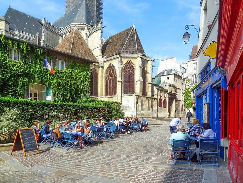 people at outdoor cafes in one of the hidden gems in Europe in Paris