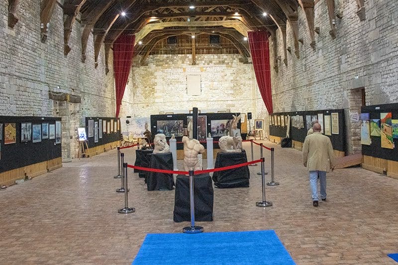 a man in a large stone warehouse