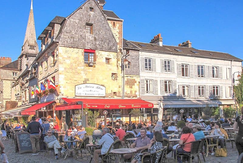 people sitting at an ancient cafe in Honfleur France