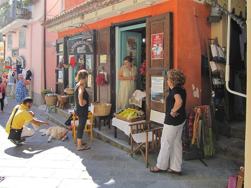 people at a vegetable stand in one of the Italian hill towns